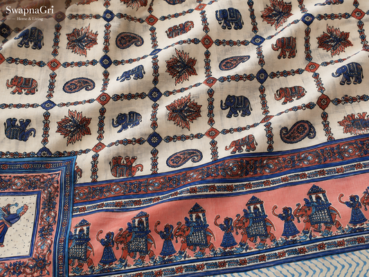 Close-up of matching pillow covers with blue, cream and coral ethnic elephant and floral print