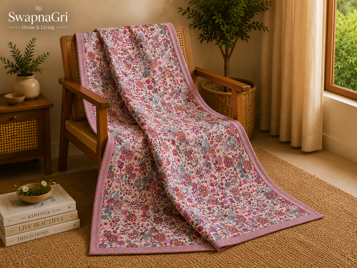 Folded pink floral cotton dohar showing the printed fabric and border