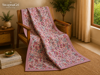 Folded pink floral cotton dohar showing the printed fabric and border