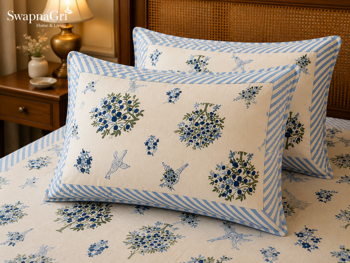 Close-up of SwapnaGri blue floral and bird print pillow covers and bedsheet