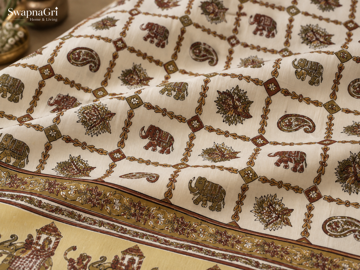 Detailed view of decorative border and folk elephant motifs on cotton bedsheet