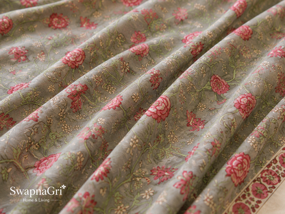 Close-up of grey cotton fabric with pink floral and paisley print