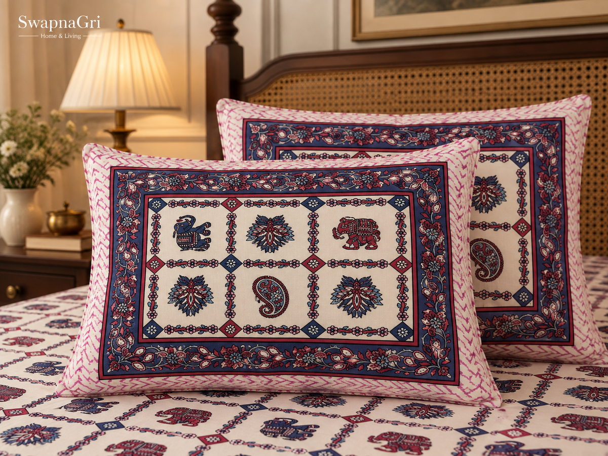 Close-up of matching pillow covers with pink and blue elephant, floral and paisley motifs