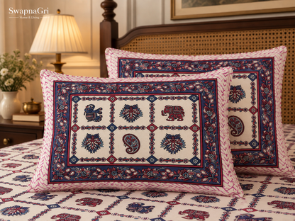 Close-up of matching pillow covers with pink and blue elephant, floral and paisley motifs